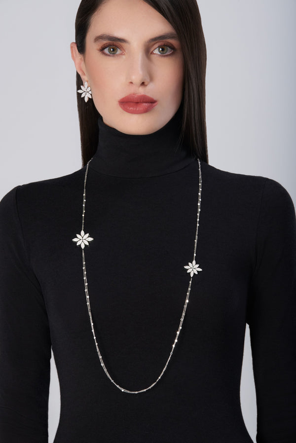 Sautoir and earrings in 18k White Gold with White Diamonds on model wearing black turtleneck