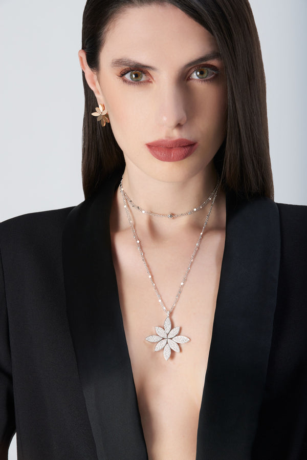 Necklace and earrings in 18k White Gold with White Diamonds on model wearing a black jacket