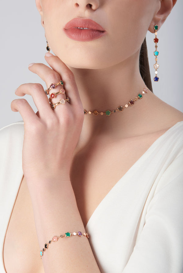 Jewelry set in 18k Rose Gold with coloured gemstones and White Diamonds shown on model in white outfit