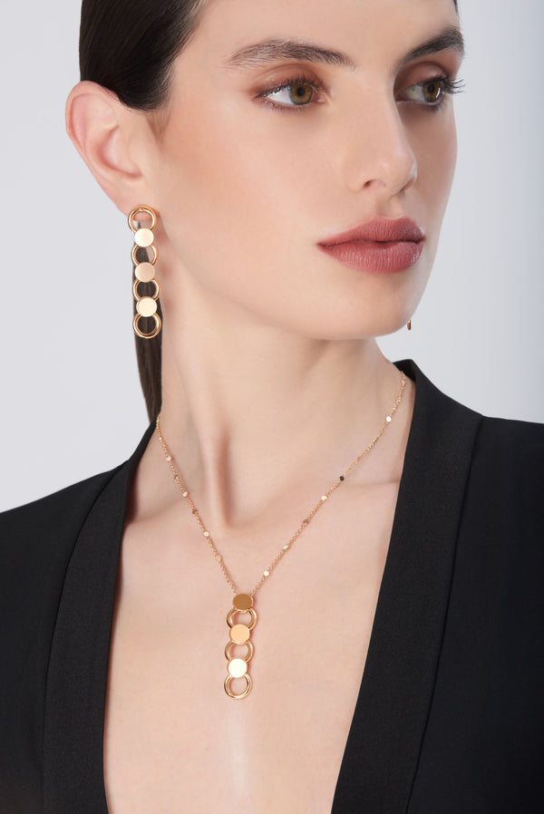 Matching earrings with 18K rose gold necklace with circular motifs on model