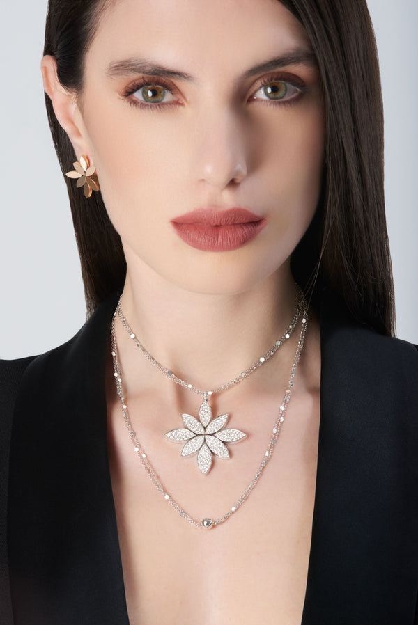 Necklace and earrings in 18k White Gold with White Diamonds on model wearing a black jacket