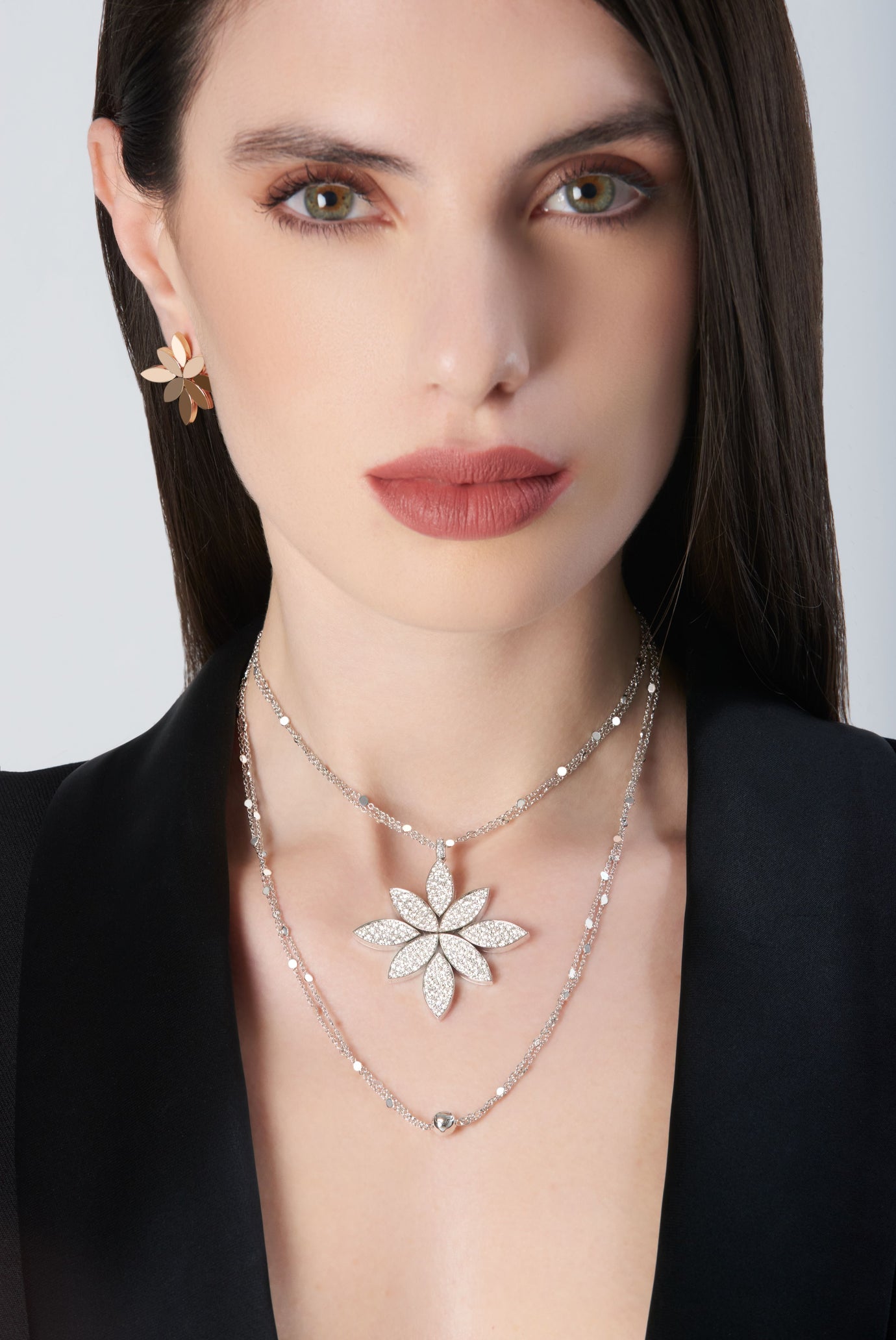 Necklace and earrings in 18k White Gold with White Diamonds on model wearing a black jacket