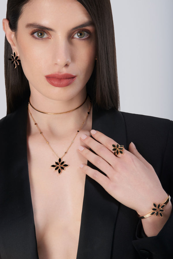 Necklace, Bracelet, Ring and Earrings in 18k Rose Gold with Onyx on model wearing a black jacket