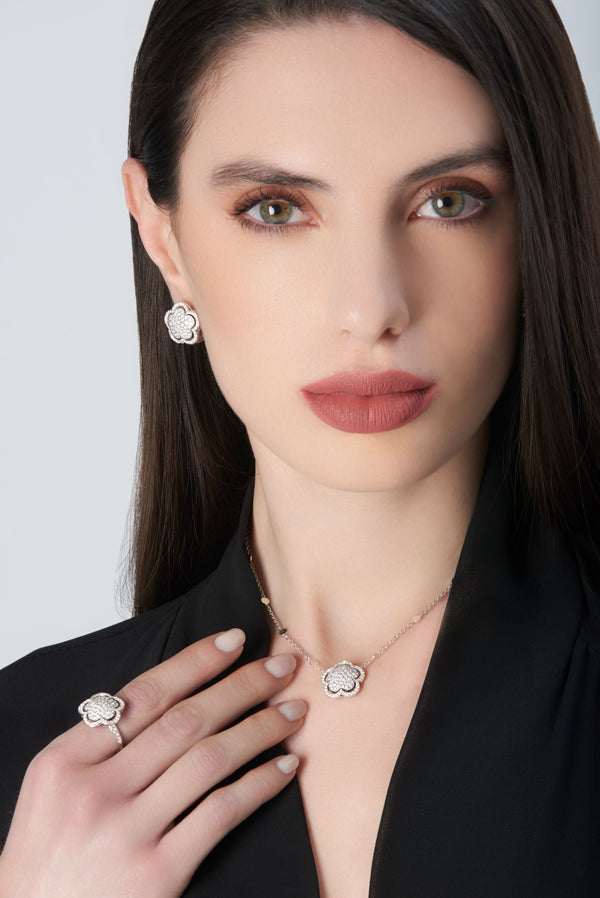 Necklace, earrings, and ring in 18k white gold with diamonds on model in black shirt