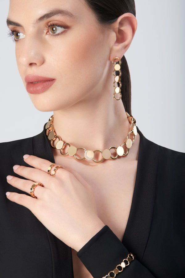 Jewelry set in 18k rose gold on model in black blazer