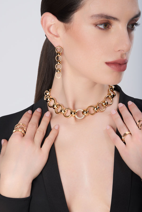 Necklace and pendant earrings in 18k Rose Gold, wearing on model in black jacket