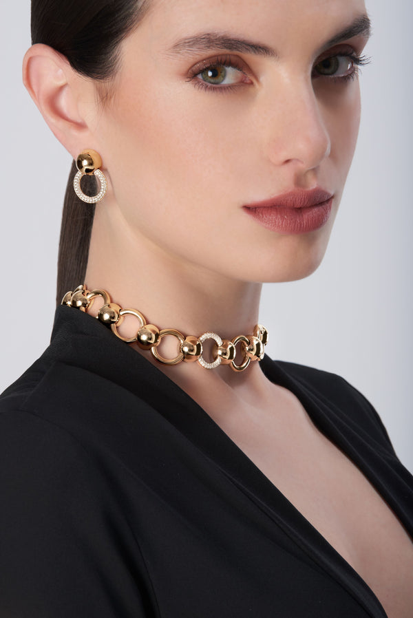 Choker and hoop earrings in 18k gold with diamonds, worn by model in black blazer