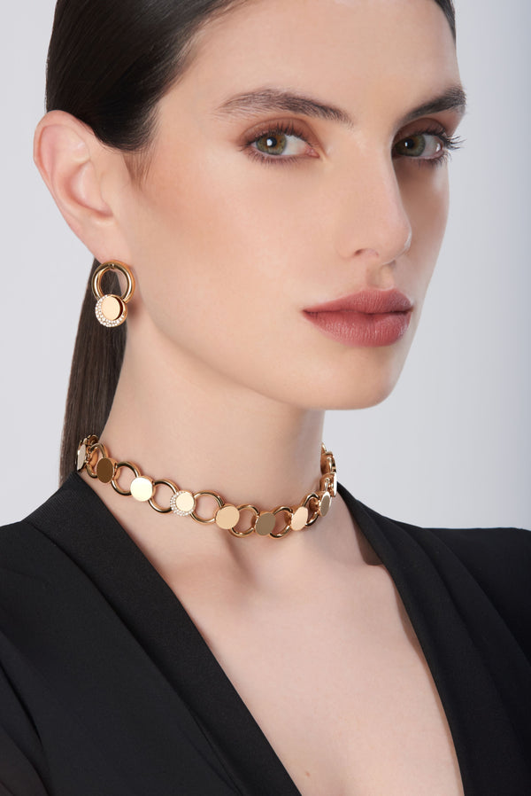 Choker and earring in 18k rose gold with circle motifs worn with black blazer