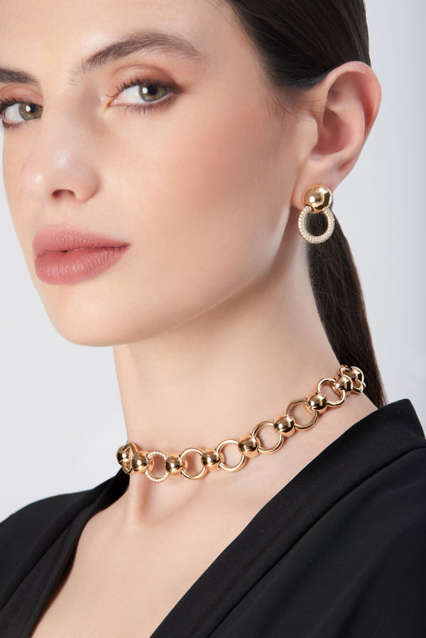 Choker and earring in 18k rose gold with diamond accents on model wearing a black outfit