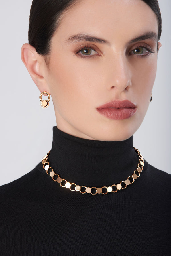Choker and earrings in 18k gold with diamonds, worn with a black turtleneck sweater