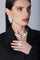 Woman wearing a black jacket and Ring, collier and earrings in 18k White Gold with White Diamonds.