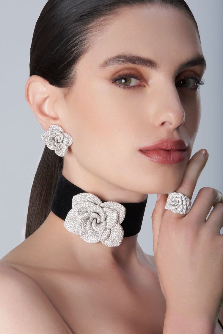 Woman wearing a black velvet choker, ring and earrings