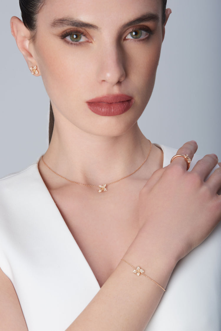 Necklace, ring, bracelet and earrings in 18k Rose Gold with Diamonds on model.