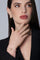 Woman wearing a black jacket and earrings, ring, and bracelet in 18k Rose Gold with diamonds