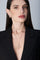 Model wearing a black jacket and earrings and becklace in 18k Rose Gold with Diamonds