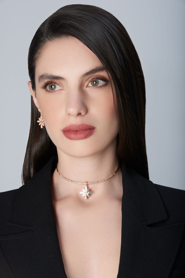 Model wearing a black jacket and earrings and choker in 18k Rose Gold with Diamonds