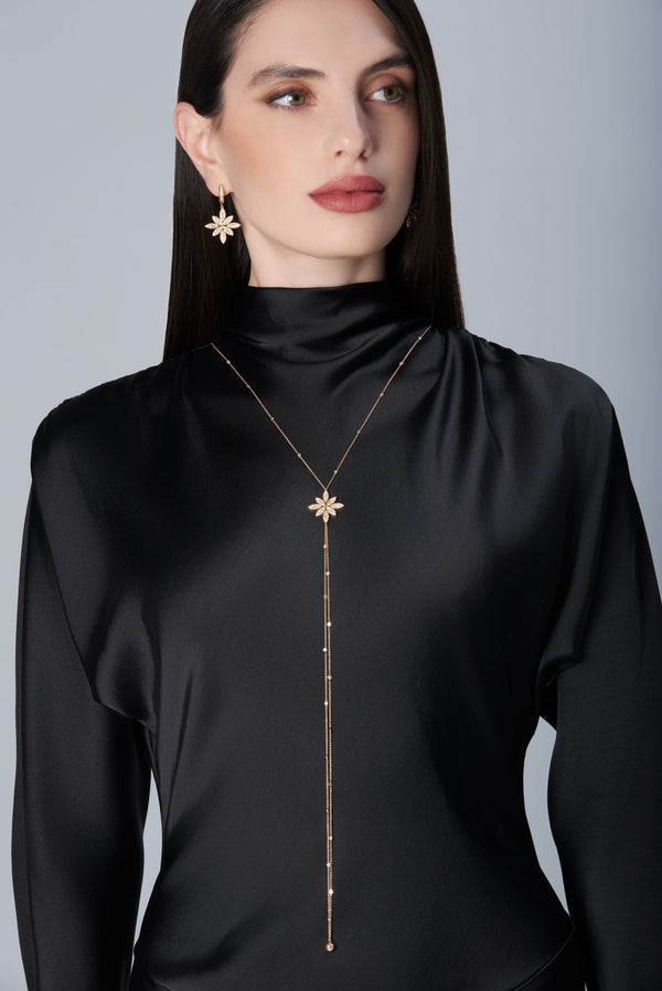 Model wearing a black dress and Sautoir and earrings in 18k Rose Gold with Diamonds