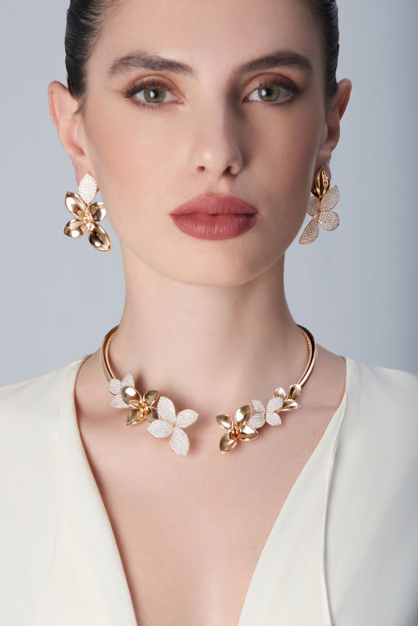 Model wearing a white dress and Choker and earrings in 18k Rose Gold with Diamonds.