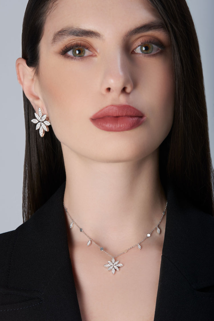 Model wearing earrings and necklace in 18k White Gold with White Diamonds with a black jacket.
