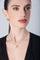 Necklace and earrings in 18k Rose Gold with Diamonds on model with black shirt