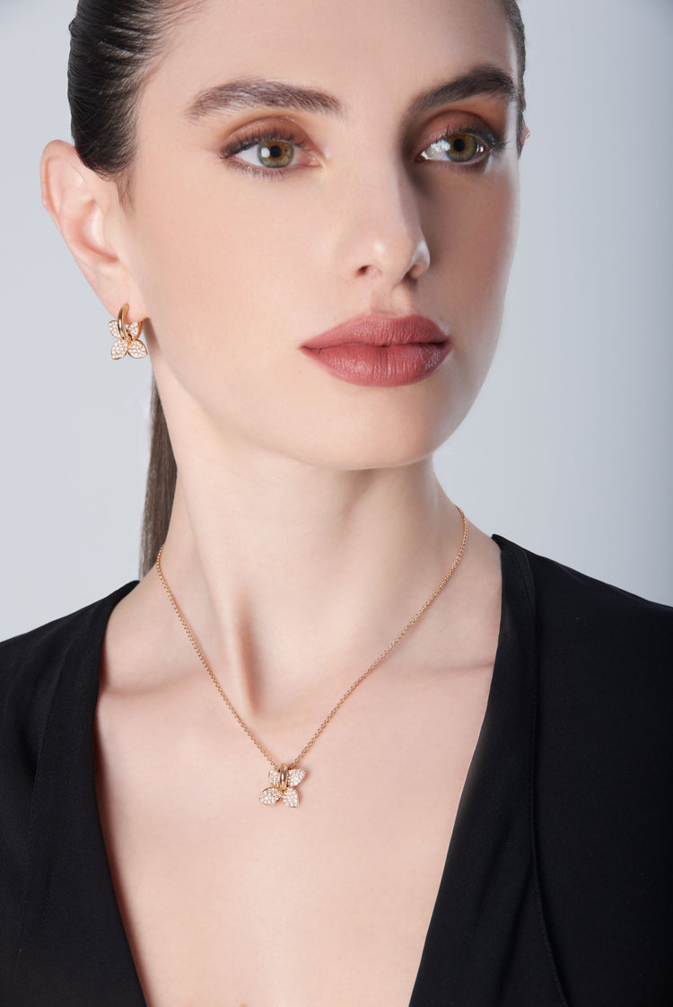 Necklace and earrings in 18k Rose Gold with Diamonds on model with black shirt