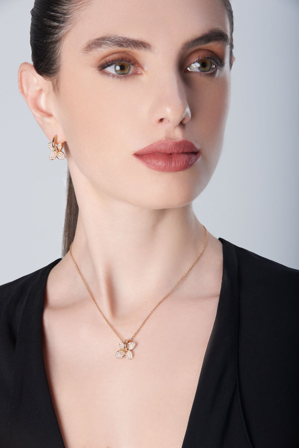 Necklace and earrings in 18k Rose Gold with Diamonds on model with black shirt
