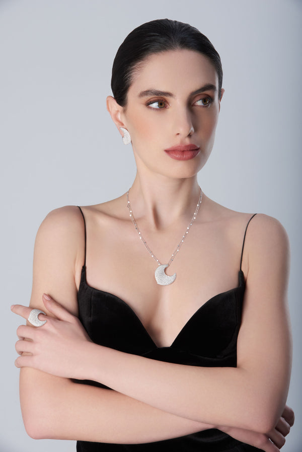 Woman wearing diamond earrings, ring and necklace in 18k White Gold with white diamonds