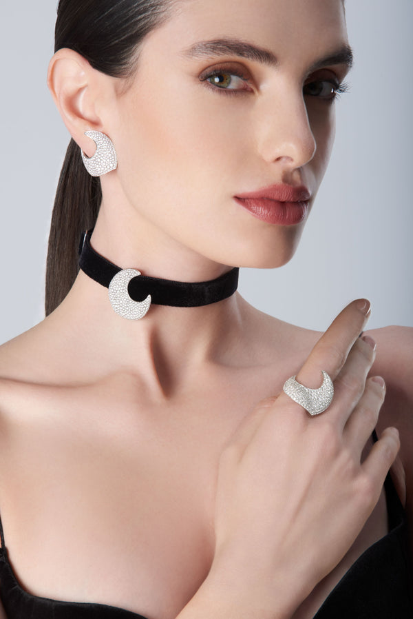 Woman wearing a black choker, earrings, and ring in 18k white gold with diamonds