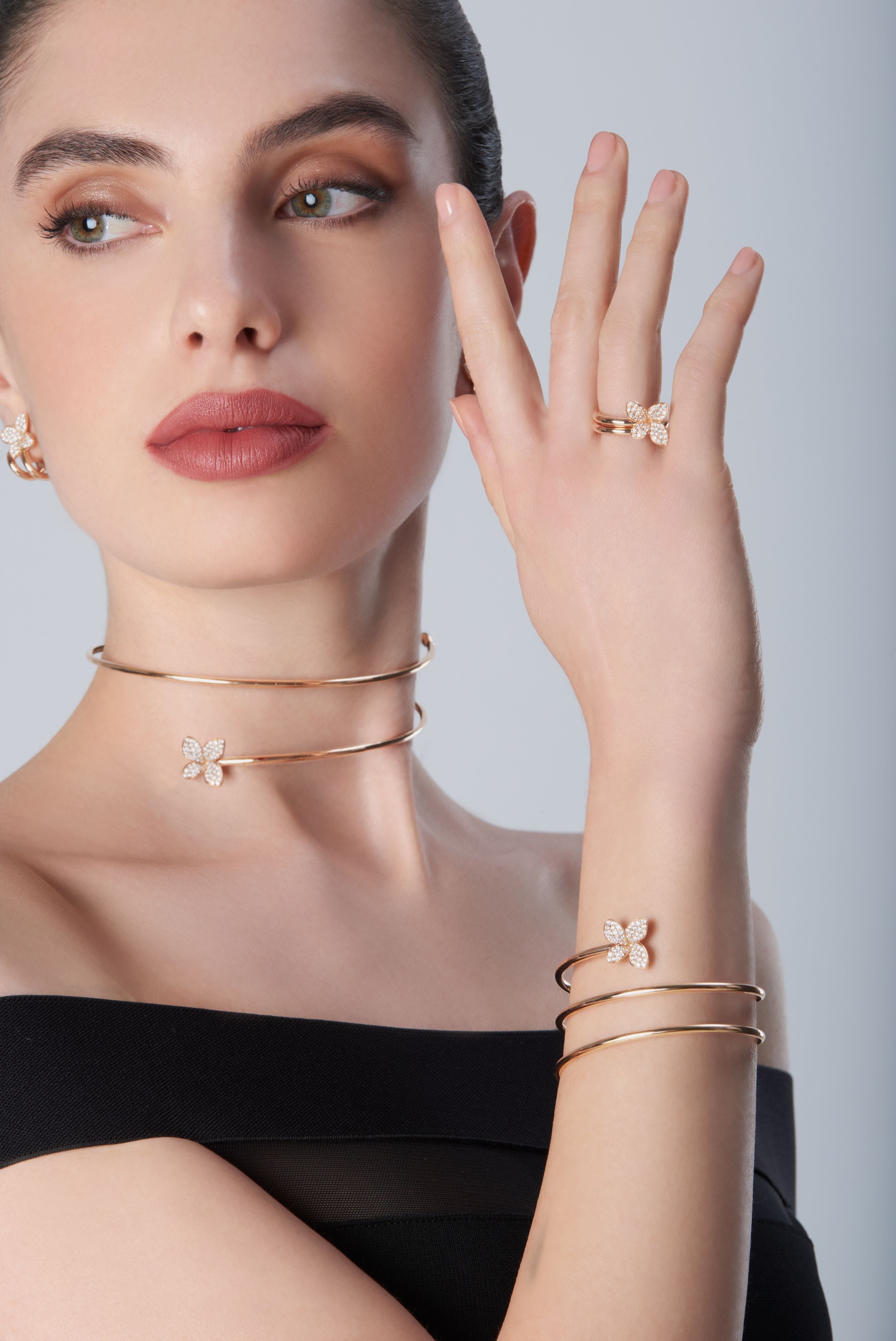 Combination of choker, bracelet and ring in 18k Rose Gold with Diamonds on model with black dress