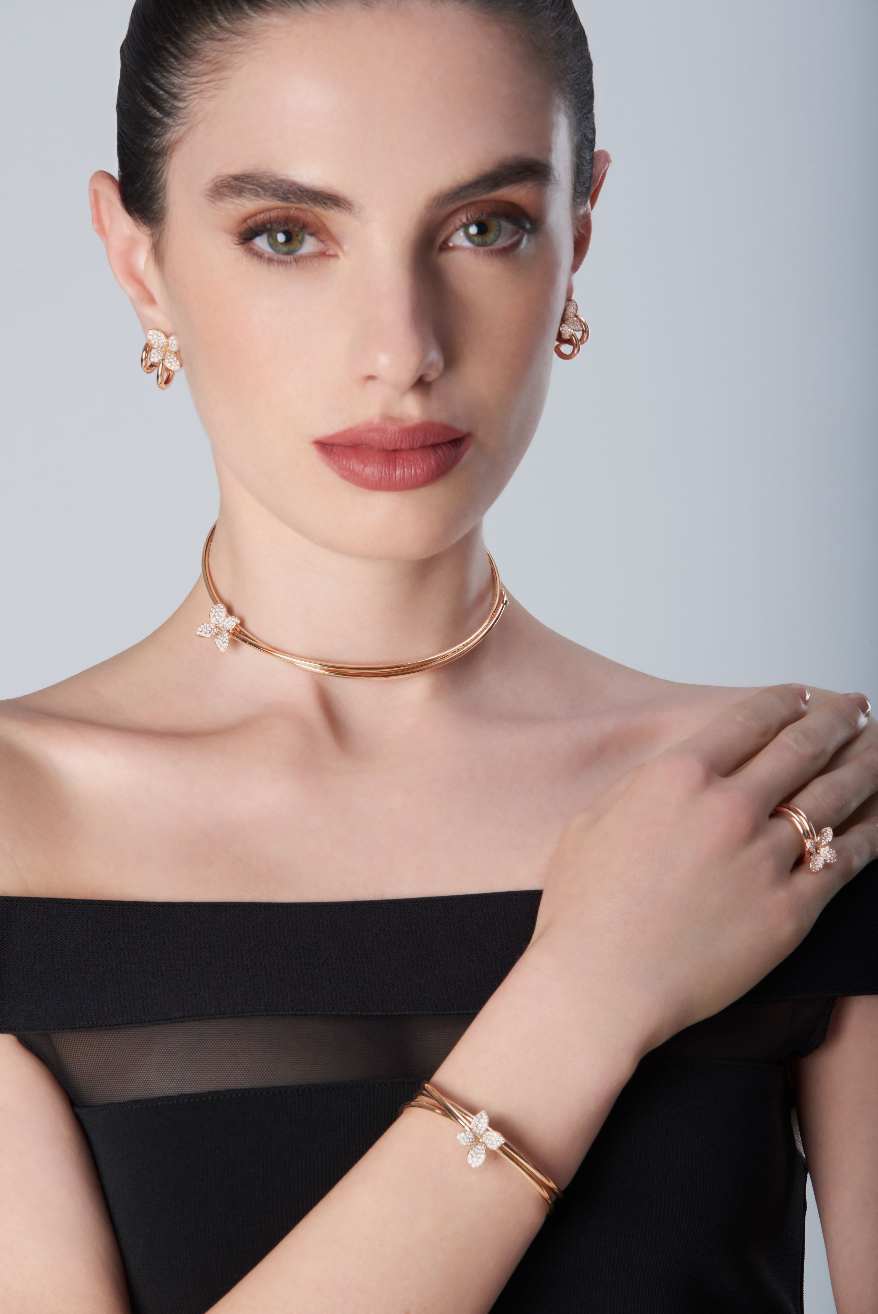 Combination of choker, bracelet and ring in 18k Rose Gold with Diamonds on model with black dress