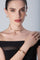 Choker, earrings, bracelet and ring in 18k Rose Gold with Diamonds on model with black dress