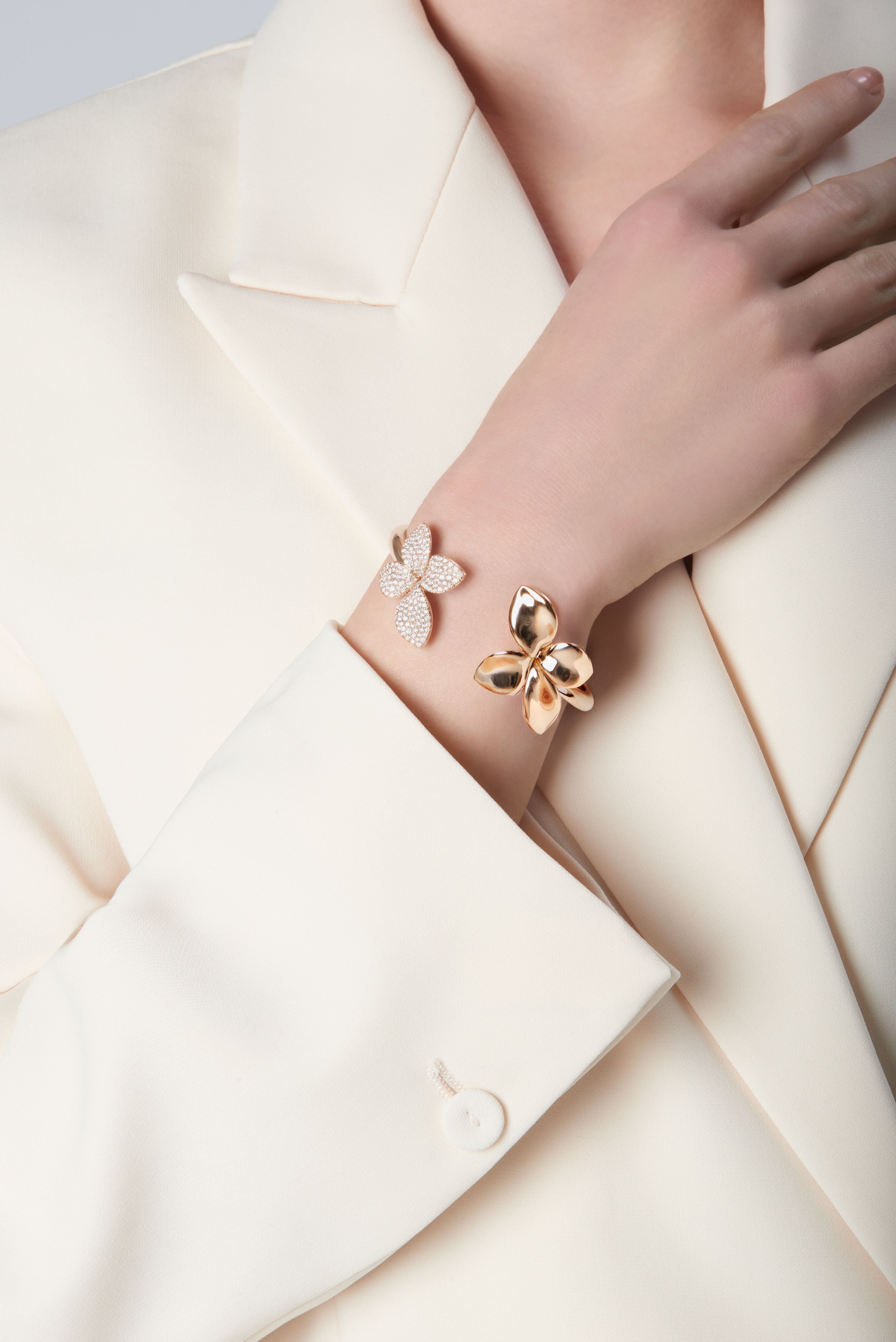 Model wearing a cream jacket and Bracelet in 18k Rose Gold with Diamonds