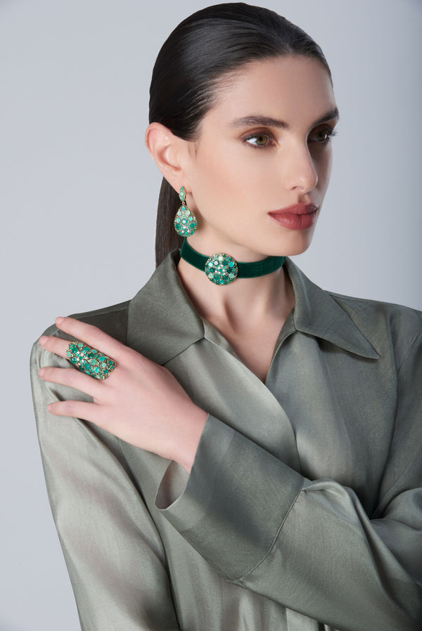 Earrings, choker with Green Velvet and ring with diamonds and green gemstones on model with a green dress
