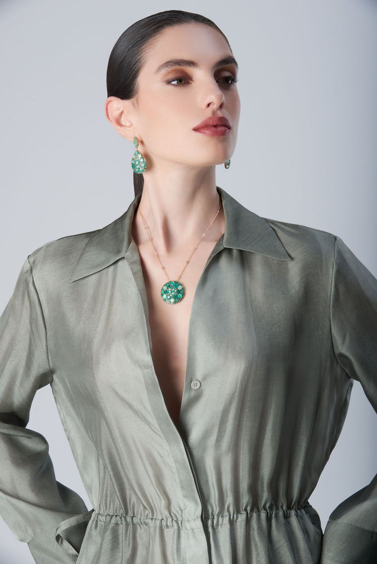 Earrings and necklace with Green Velvet, diamonds and green gemstones on model with a green dress
