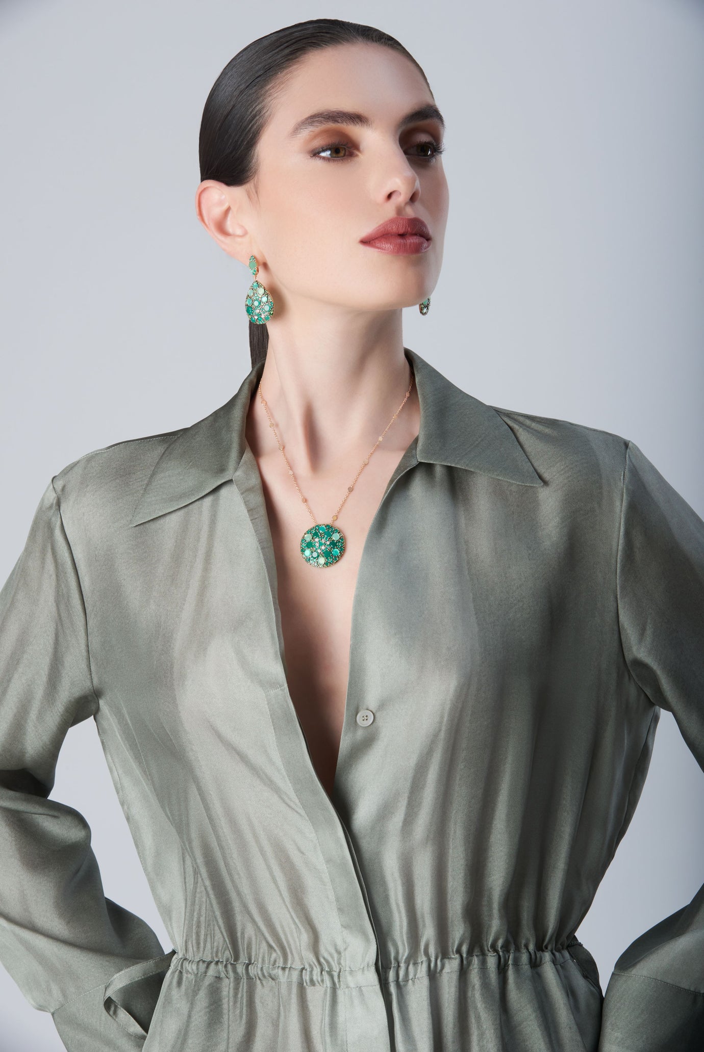 Earrings and necklace with Green Velvet, diamonds and green gemstones on model with a green dress