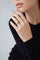 Model wearing a 18k rose gold and grey titanium and a black top with long sleeves