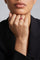 Model wearing a Ring in 18k Rose Gold with Rubies and a black blazer