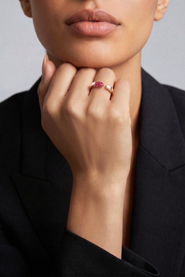 Model wearing a Ring in 18k Rose Gold with Rubies and a black blazer