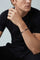 Model with a black tshirt wearing a Bracelet in 18k Rose Gold and Black titanium with white and champagne diamonds