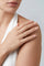 Model with a ring in 18k Rose Gold with white and champagne diamonds and a white top