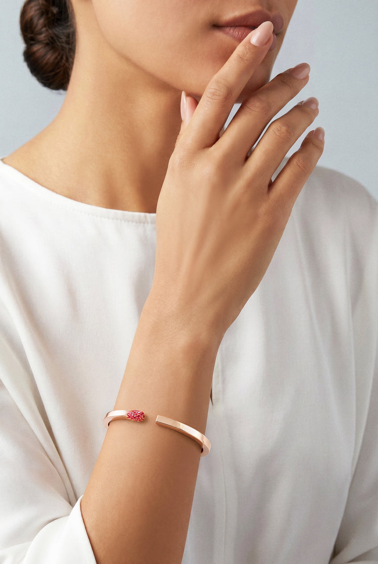 Model wearing a Bracelet in 18k rose gold with rubies and white top