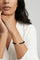 Model wearing a V neck top and a Bracelet in 18k Rose Gold and Black Titanium with White and Champagne Diamonds.