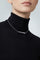 Model wearing a Necklace in 18k White Gold with white diamonds and a black turtleneck