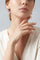 Model wearing Earrings in 18k rose gold with rubies and white shirt