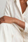 Model wearing a total white look and a Bracelet in 18k White gold with white diamonds