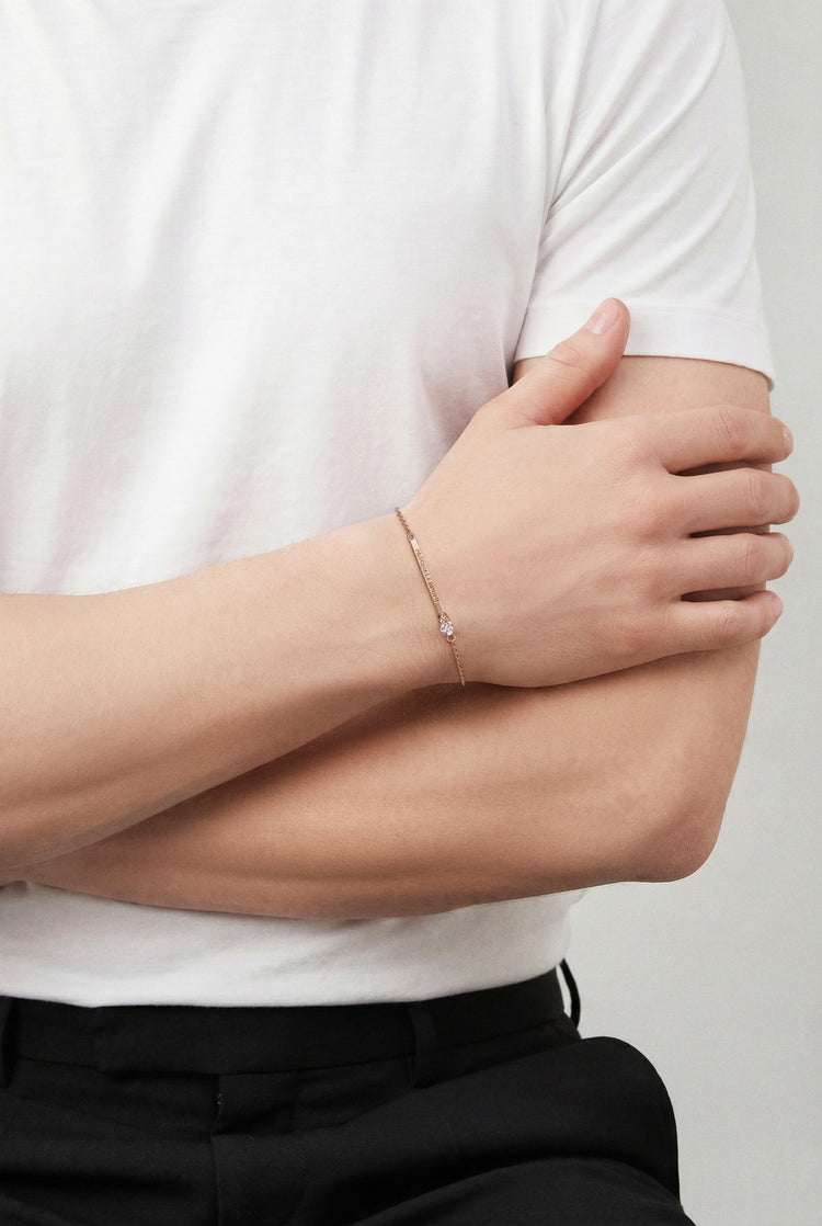 Model wearing a white tshirt and a Bracelet in 18k Rose gold with white and champagne diamonds