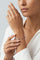 Model wearing a V neck white top and Bracelet in 18k Rose Gold and Grey Titanium