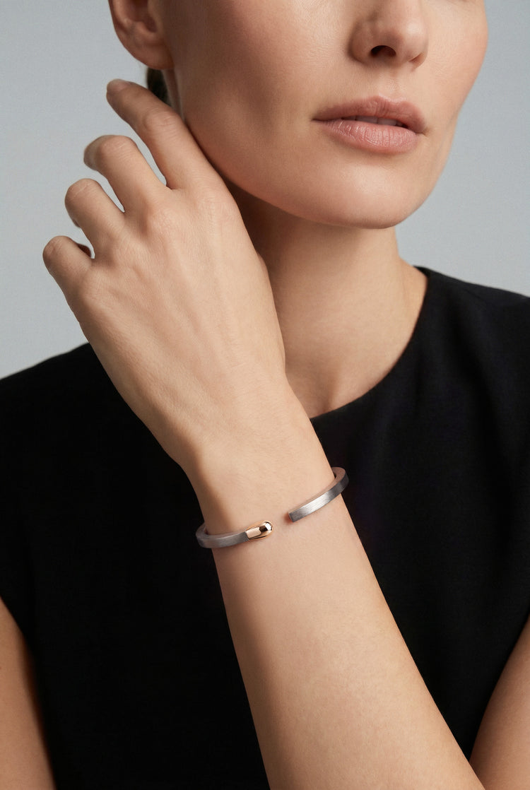 Model wearing a black shirt and Bracelet in 18k Rose Gold and Grey Titanium