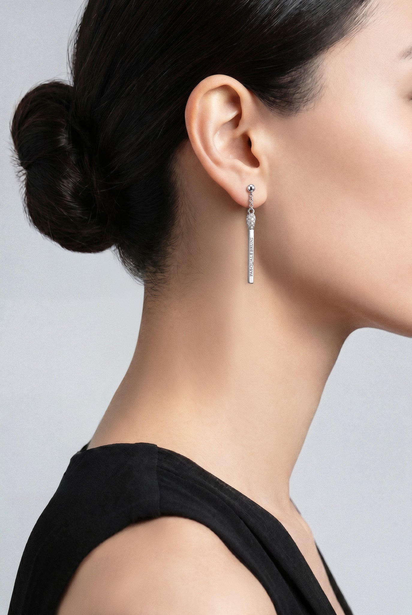 Model wearing a Earrings in 18k White gold with white diamonds and a black top