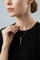 Model wearing a black top and Necklace in 18k Rose gold with Rubies